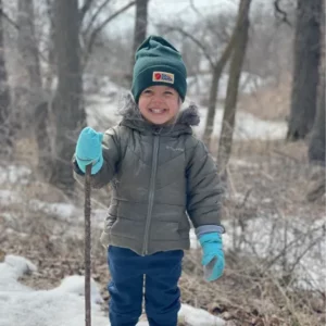 Craig C submitted this picture of his child in winter gear, smiling and enjoying a crisp day in the woods