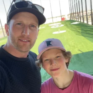 Taylor D., support of FMSM, submitted a photo of he and his child taken at a golf driving range.