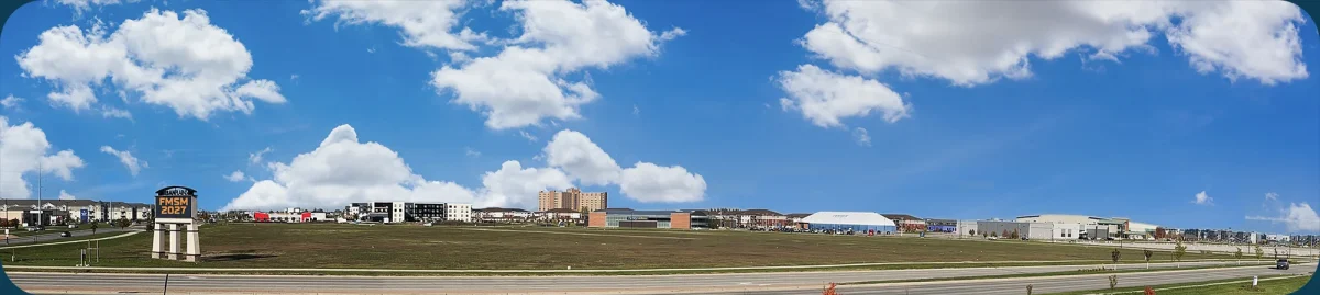 Panoramic image of the UP site showing the lot and you can see Sanford in the background, as well as the Family Wellness center and Scheels Arena